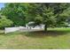 Spacious backyard featuring a fenced yard with mature trees that enhance the property's privacy and appeal at 8136 Connally Dr, Douglasville, GA 30134