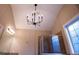 Bathroom featuring frameless glass shower, soaking tub, modern lighting fixture and large window at 319 Barbados Ln, Suwanee, GA 30024