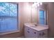 Bright bathroom featuring a large window over a single sink white vanity at 319 Barbados Ln, Suwanee, GA 30024