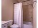 Bathroom featuring tile surround shower with tub and decorative white curtain and fixtures at 319 Barbados Ln, Suwanee, GA 30024