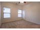A serene bedroom featuring two windows with blinds and neutral carpeting and paint at 319 Barbados Ln, Suwanee, GA 30024