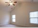 Bedroom with a vaulted ceiling, ceiling fan and two windows providing natural light at 319 Barbados Ln, Suwanee, GA 30024