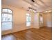 Bright dining room with wainscoting, hardwood flooring, and decorative lighting fixture at 319 Barbados Ln, Suwanee, GA 30024