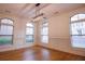 Elegant dining room with hardwood flooring, arched windows, and modern light fixture at 319 Barbados Ln, Suwanee, GA 30024