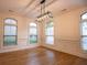 Bright dining room with hardwood floors, wainscoting and traditional lighting fixture at 319 Barbados Ln, Suwanee, GA 30024