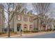 Charming three-story brick home with red shutters and manicured landscaping at 319 Barbados Ln, Suwanee, GA 30024
