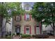 Charming two-story brick home featuring red shutters, manicured landscaping, and a welcoming front entrance at 319 Barbados Ln, Suwanee, GA 30024