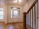 Bright foyer boasts hardwood floors and a staircase with wooden banister and black metal spindles at 319 Barbados Ln, Suwanee, GA 30024