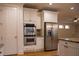 Modern kitchen with stainless steel appliances, double oven, and white cabinets at 319 Barbados Ln, Suwanee, GA 30024