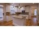 Bright kitchen boasts a center island, granite countertops, and stainless steel appliances at 319 Barbados Ln, Suwanee, GA 30024