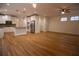Open-concept kitchen featuring white cabinets, a center island, stainless appliances, and hardwood flooring at 319 Barbados Ln, Suwanee, GA 30024