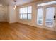 Living room featuring a ceiling fan, fireplace, a door to the exterior, and gleaming hardwood floors at 319 Barbados Ln, Suwanee, GA 30024