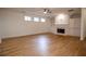 Spacious living room featuring a fireplace, built in shelving, and hardwood floors at 319 Barbados Ln, Suwanee, GA 30024