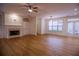Spacious living room features a fireplace, built in shelving, ceiling fan, and access to the patio at 319 Barbados Ln, Suwanee, GA 30024