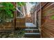 Multi-level backyard featuring stone steps, wooden privacy fencing, and lush plantings at 625 Kennesaw Ave, Atlanta, GA 30308
