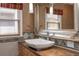 Bathroom featuring a vessel sink, decorative mirror, and natural light from the window at 625 Kennesaw Ave, Atlanta, GA 30308