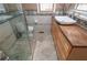 Stylish bathroom featuring an undermount sink, wood cabinets, and tiled floor with a walk-in shower and toilet at 625 Kennesaw Ave, Atlanta, GA 30308
