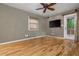 Hardwood floors and ample natural light illuminate this bedroom with a ceiling fan and door to the outside at 625 Kennesaw Ave, Atlanta, GA 30308