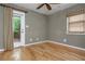 Cozy bedroom features a wood floor, ceiling fan, and access to the outdoor deck at 625 Kennesaw Ave, Atlanta, GA 30308