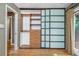 Bedroom with hardwood floors and a built in closet with sliding doors and wood drawers at 625 Kennesaw Ave, Atlanta, GA 30308