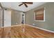 Bedroom with hardwood floors, neutral walls, ceiling fan, and a large window with woven blinds at 625 Kennesaw Ave, Atlanta, GA 30308