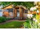 Charming home featuring a welcoming porch, complemented by lush landscaping and a brick pathway leading to the entrance at 625 Kennesaw Ave, Atlanta, GA 30308