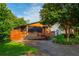 A cozy home with a screened porch, highlighted by a well-maintained lawn, mature trees, and a private fenced yard at 625 Kennesaw Ave, Atlanta, GA 30308