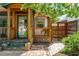 Inviting front porch with wood columns, glass front door, and a brick walkway at 625 Kennesaw Ave, Atlanta, GA 30308