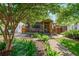 Charming home featuring a lush front yard with a brick walkway leading to a covered porch at 625 Kennesaw Ave, Atlanta, GA 30308