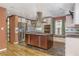 Stunning kitchen showcasing a large island, stainless steel appliances, a tile backsplash and hardwood floors at 625 Kennesaw Ave, Atlanta, GA 30308