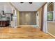 Sunlit living room with hardwood floors, a view of kitchen, and a neutral color palette with a light fixture at 625 Kennesaw Ave, Atlanta, GA 30308