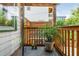 Charming wood porch with potted plants overlooking fenced yard. Includes view of neighboring home at 625 Kennesaw Ave, Atlanta, GA 30308