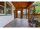 Charming covered porch featuring slate flooring, wood ceiling and columns, with views to fenced outdoor space at 625 Kennesaw Ave, Atlanta, GA 30308