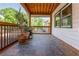 Inviting covered porch with slate flooring, wood-paneled ceiling and lots of space for potted plants at 625 Kennesaw Ave, Atlanta, GA 30308