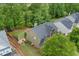 An aerial view of the home and backyard, showcasing the screened deck, patio, playset, and surrounding greenery at 6250 Vista Crossing Way, Cumming, GA 30028