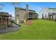 Large backyard with a well-maintained lawn, a patio, playground and mature landscaping at 6250 Vista Crossing Way, Cumming, GA 30028