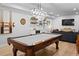Finished basement with pool table, wet bar, and media area for relaxing and entertaining at 6250 Vista Crossing Way, Cumming, GA 30028