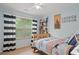 Comfortable bedroom with playful decor and plenty of natural light at 6250 Vista Crossing Way, Cumming, GA 30028