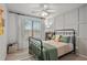 Comfortable bedroom featuring a decorative ceiling fan and light-blocking curtains at 6250 Vista Crossing Way, Cumming, GA 30028