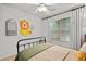 Charming bedroom featuring neutral walls, a black metal bed frame and lots of natural light at 6250 Vista Crossing Way, Cumming, GA 30028