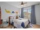 Well-decorated bedroom with blue accents, a ceiling fan, and a window at 6250 Vista Crossing Way, Cumming, GA 30028