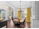 Elegant dining room with tray ceiling, chandelier, and large windows providing natural light at 6250 Vista Crossing Way, Cumming, GA 30028