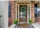 Inviting front entrance featuring a decorative wreath, stone facade, and a 'Welcome Home' doormat at 6250 Vista Crossing Way, Cumming, GA 30028