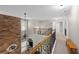 A bright hallway featuring an open view of the living room and hardwood banister at 6250 Vista Crossing Way, Cumming, GA 30028