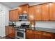 Gourmet kitchen featuring stainless steel appliances and beautiful wood cabinetry at 6250 Vista Crossing Way, Cumming, GA 30028