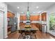 Spacious kitchen featuring a large island, stainless appliances, and hardwood floors at 6250 Vista Crossing Way, Cumming, GA 30028
