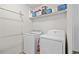 Functional laundry room with a washer, dryer, and shelving at 6250 Vista Crossing Way, Cumming, GA 30028