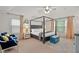 Spacious main bedroom with natural light, stylish furniture, and tray ceiling at 6250 Vista Crossing Way, Cumming, GA 30028