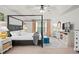 Bright main bedroom featuring a four-poster bed, ceiling fan, and elegant furnishings at 6250 Vista Crossing Way, Cumming, GA 30028