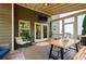 A covered outdoor patio features a dining area, lounge chairs, and a ceiling fan for comfortable entertaining at 6250 Vista Crossing Way, Cumming, GA 30028